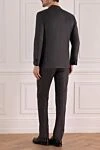 Костюм мужской из шерсти серый Corneliani - Шлица. 100% шерсть. Пуговицы, крючок. Нагрудный карман, два кармана с клапанами. Карманы (внутренние): Три кармана. Два боковых кармана, два кармана сзади на пуговицах. 100% купро. Страна производитель: Италия. Уход: специализированная чистка - фото 4