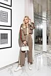 Костюм прогулянковий з поліестеру та бавовни коричневий жіночий Gucci - логотип по поверхні. дві кишені. 55% поліестер, 45% бавовна. еластичний пояс з зав'язкою, блискавка. Країна виробник: Италия. Догляд: спеціалізоване чищення - фото 8