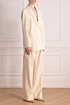 The Andamane Women's beige viscose and wool suit with trousers - vertical stripes, cuffs on trousers. 58% viscose, 39% wool. Closure: buttons. two side pockets. Country of manufacture: Italy. Care: specialized cleaning - photo 3