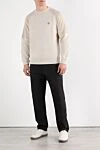 Брюки из хлопка мужские черные с логотипом Stone Island - логотипом бренда . 97% хлопок, 3% эластан. молния пуговица. два боковых кармана, два задних кармана. Страна производитель: Италия. Уход: специализированная чистка - фото 2