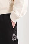 Dolce & Gabbana Брюки з джерсі з геральдичною аплікацією чорні - геральдична аплікація. 100% бавовна. дві бічні кишені, одна задня кишеня на блискавці. куліска, блискавка. Країна виробник: Італія. Догляд: спеціалізоване чищення - фото 5
